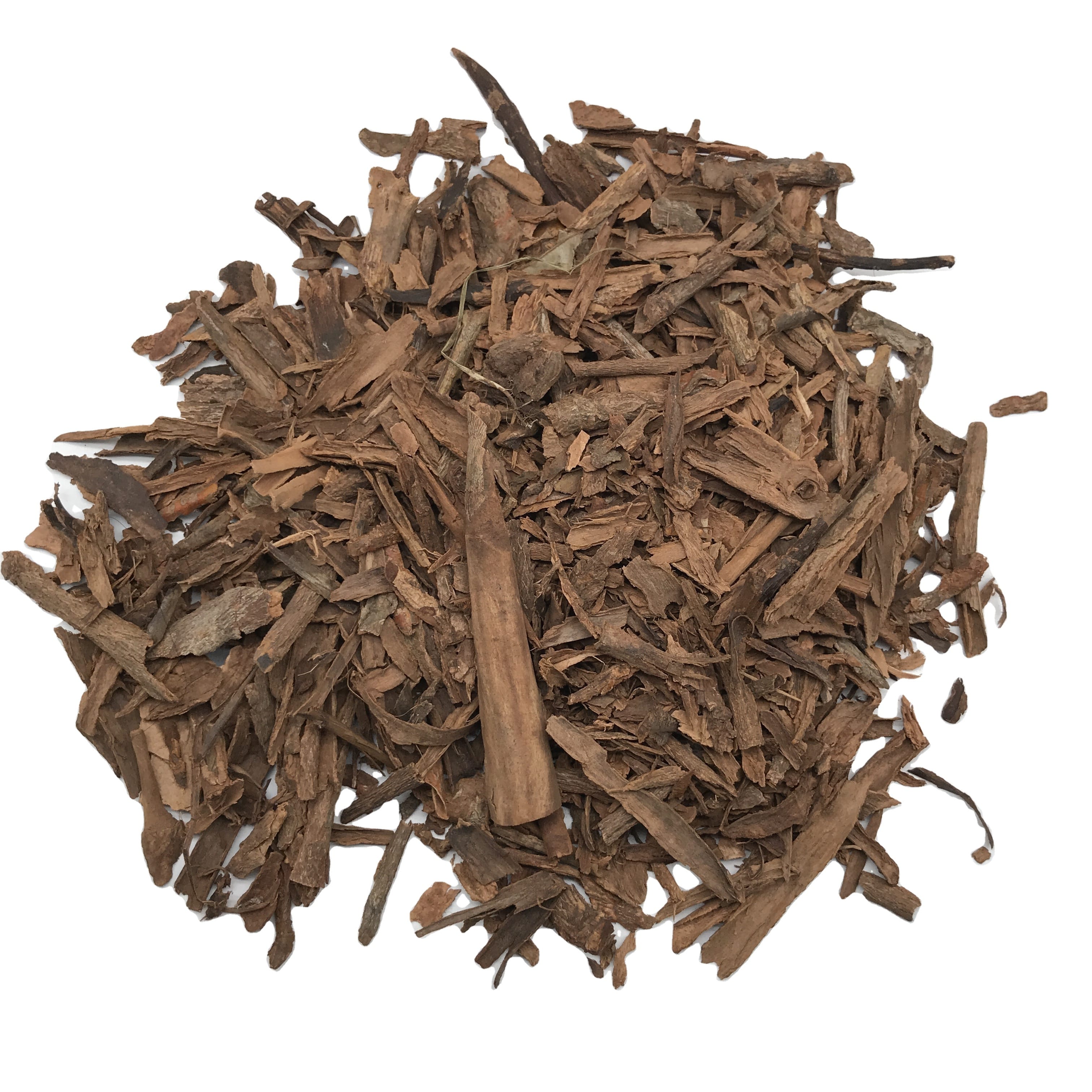 Pile of dried cassia bark pieces on a white background
