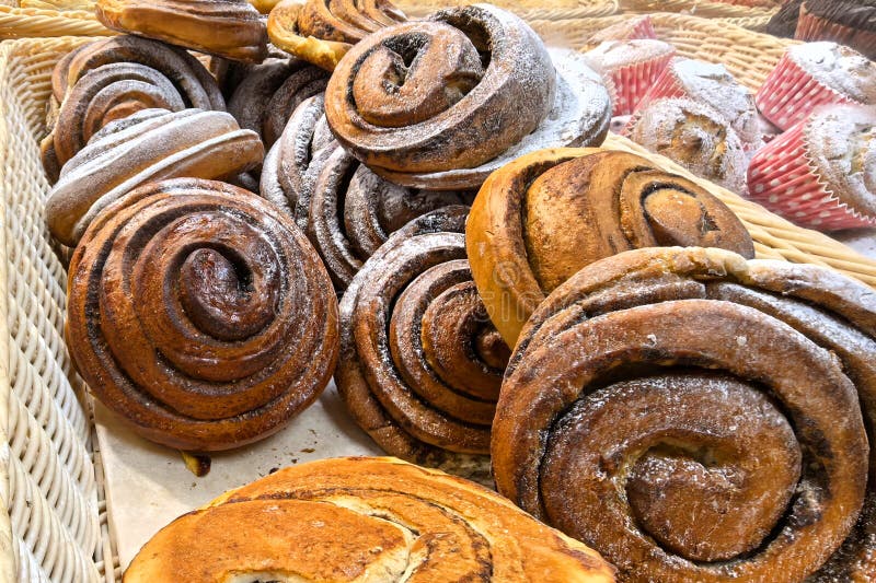 Freshly baked cinnamon rolls dusted with powdered sugar in a basket