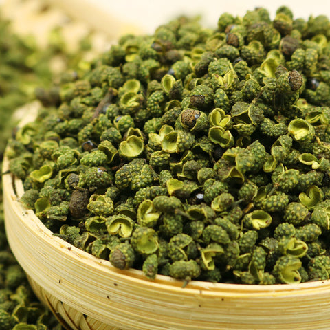 Green Sichuan peppercorns in a bamboo container