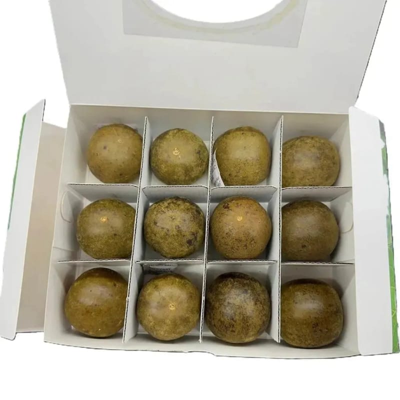 A white gift box holding twelve dried monk fruits in molded slots